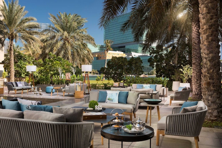 Outdoor lounge area with comfortable seating and tables