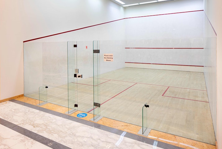 Indoor squash court with glass walls.