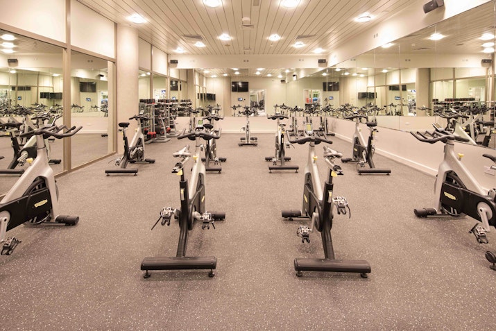 Indoor cycling studio with multiple exercise bikes.