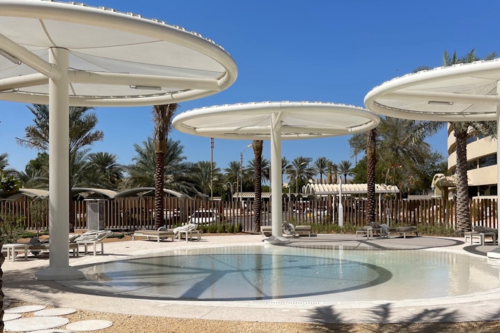 Outdoor pool area with large circular shade structures