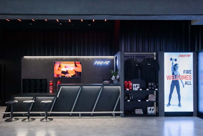 FIRE Fit FIRE Fit reception area, featuring merchandise and black walls
