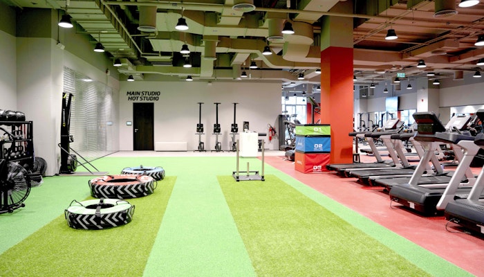 Fitness First, Zero 6 Functional training area featuring large tires, turf, sled push area, and cardio machines.