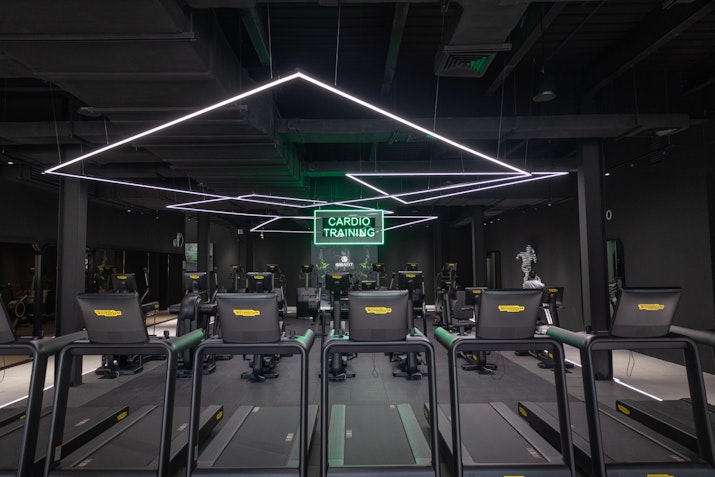 Transform Your Career with Privilee's Corporate Wellness Programme: modern gym with cardio equipment and sleek design.