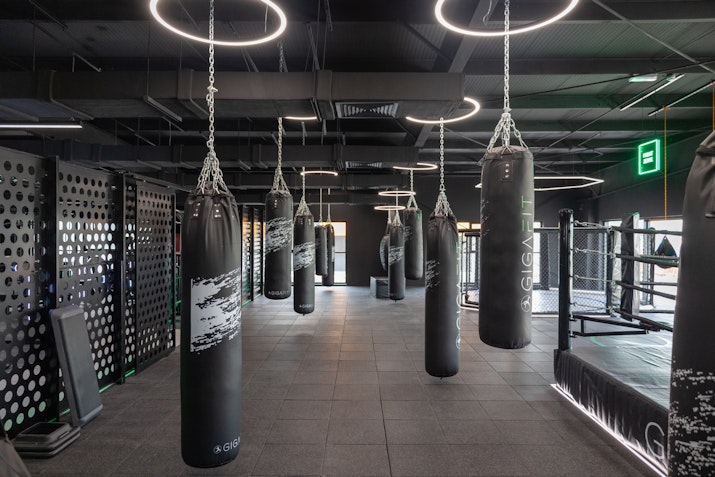 Boxing area equipped with punching bags rings, and training gear.