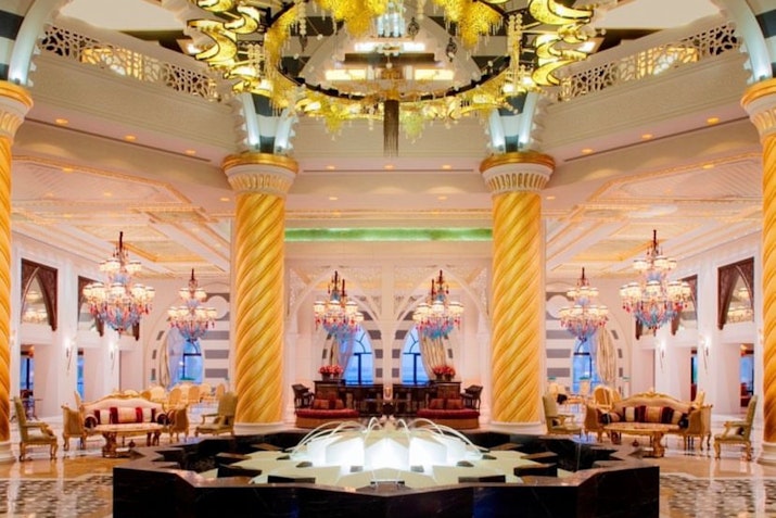 Lavish hotel lobby with grand chandeliers and ornate decor