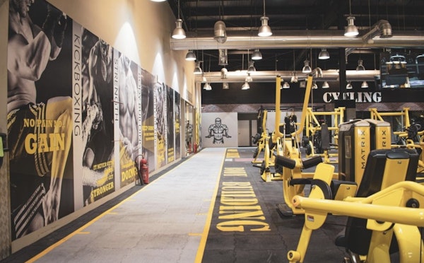 Modern gym space at Max Burn Gym with high-intensity training equipment and weightlifting stations.