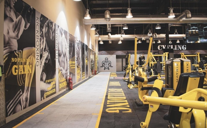Modern gym space at Max Burn Gym with high-intensity training equipment and weightlifting stations.