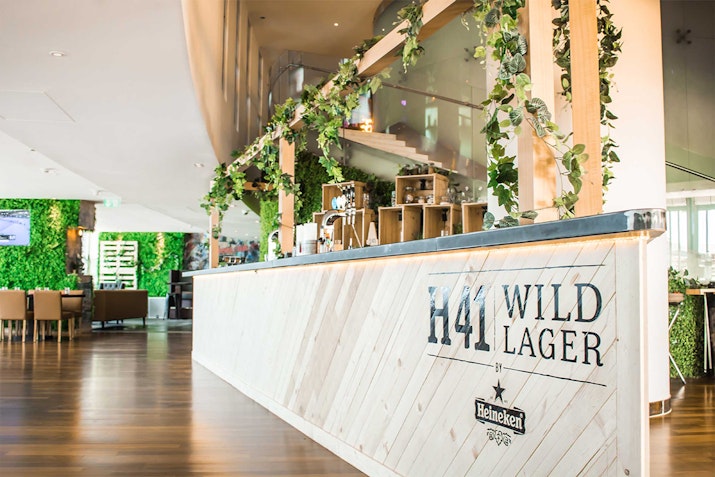 Media One Hotel Modern bar with greenery and signage for H41 Wild Lager