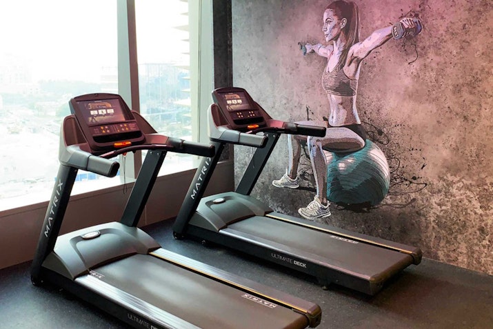 Media One Hotel Treadmills in a gym with motivational wall art