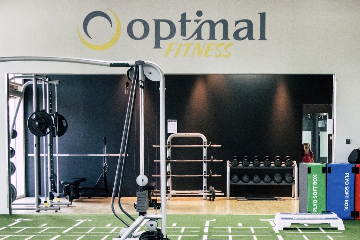 Optimal Fitness Interior of Optimal Fitness gym featuring exercise equipment and a logo