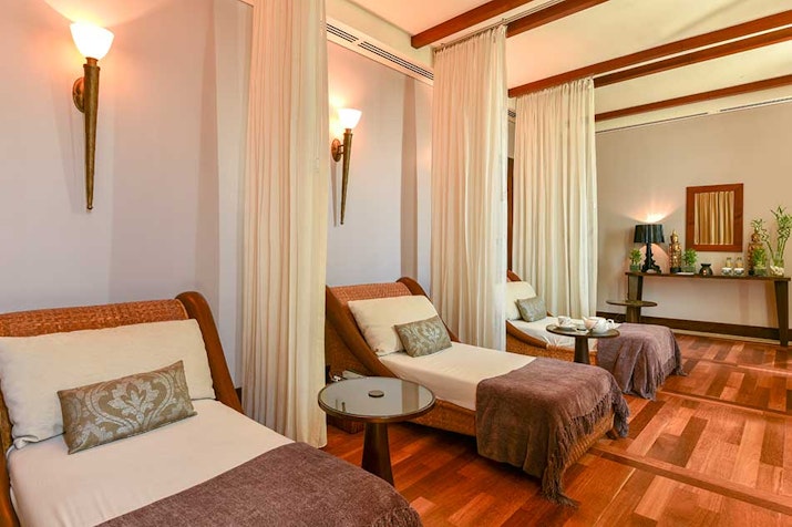 Calm spa area featuring three relaxation loungers with soft lighting and decorative accents.