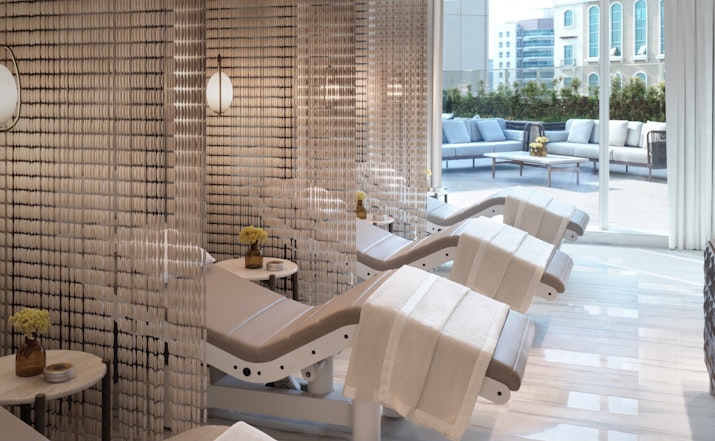 Luxurious spa treatment area with massage beds and modern decor.