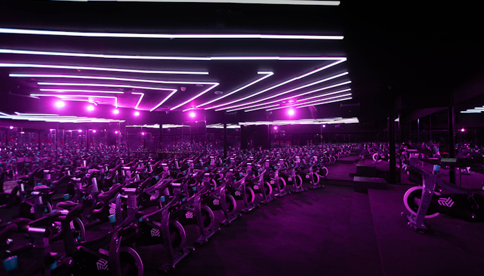 The LAB Studios Indoor cycling class at SYCLE in The LAB Studio, featuring stationary bikes and dynamic lighting for an immersive experience.