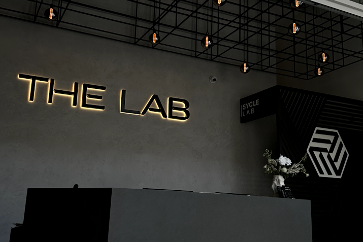 Reception area at The LAB Studios featuring grey washed walls and a black reception desk