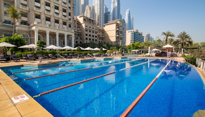 Lap pool at The Westin Dubai Mina Seyahi Beach Resort & Marina Outdoor lap pool with city skyscrapers and lounge chairs in the background.