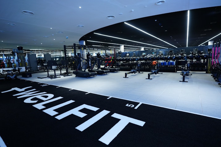 Private ftness area with sled track, weights, and functional training machines such as rowers and running machines