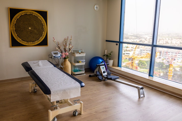 Room with large window and massage table at Yoga Ashram