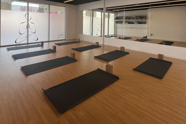 Serene yoga studio at Zen Yoga, with mats and soft lighting for a calming practice environment.