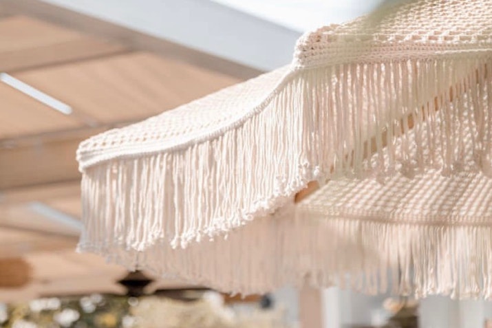 Close-up of a fringed fabric umbrella.