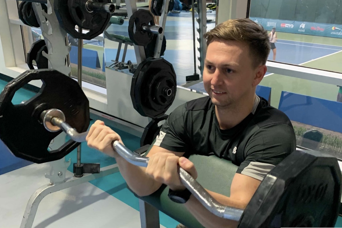 Privilee Team Spotlight Matt Person lifting weights in the gym.