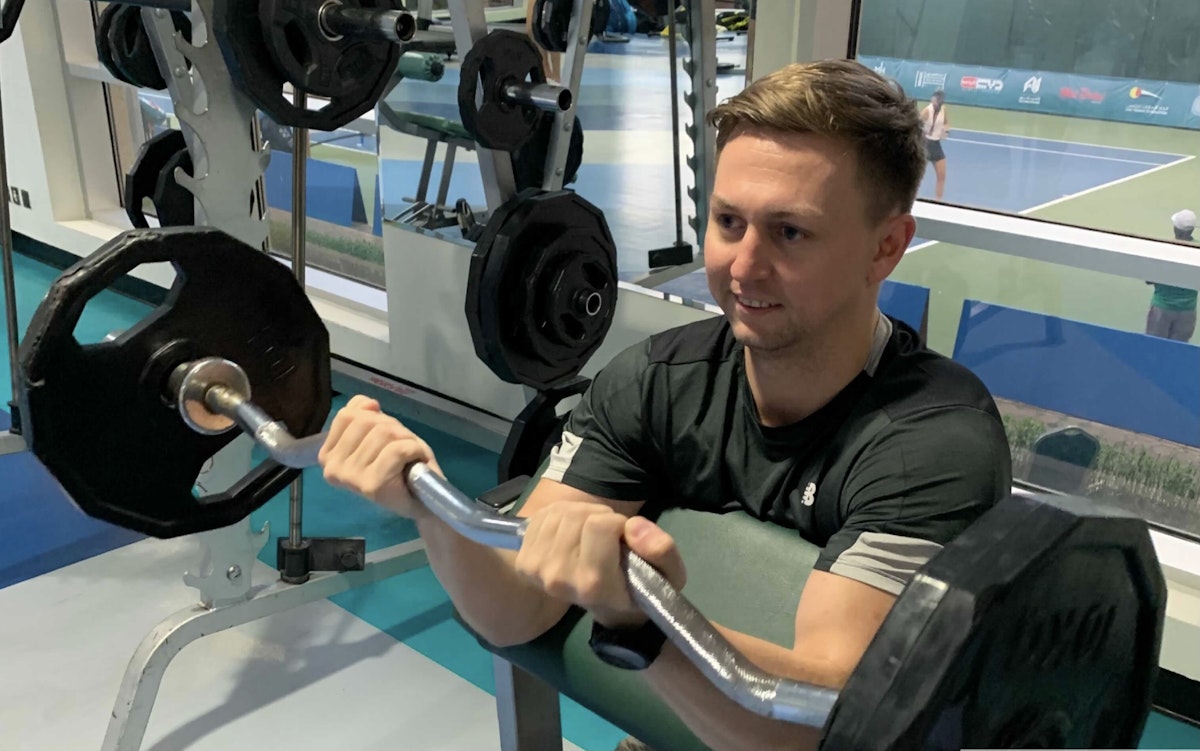 Person lifting weights in the gym.