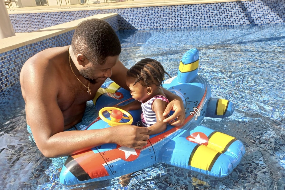 Privilee Team Spotlight: Seun Father and child playing in the pool on a toy airplane float.