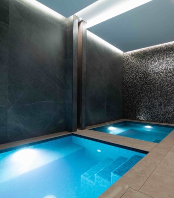 Fly High Fitness plunge pool Small plunge pools in a dimly lit room with grey tiles walls
