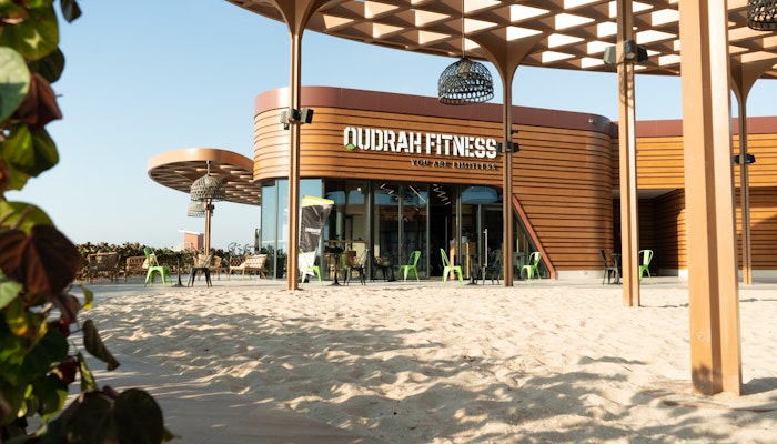 Qudrah Fitness Outdoor fitness center with modern architecture and sand-covered surroundings