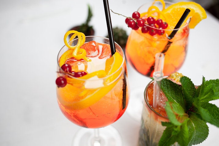 Refreshing cocktails crafted to perfection. Colorful cocktails garnished with citrus and berries.