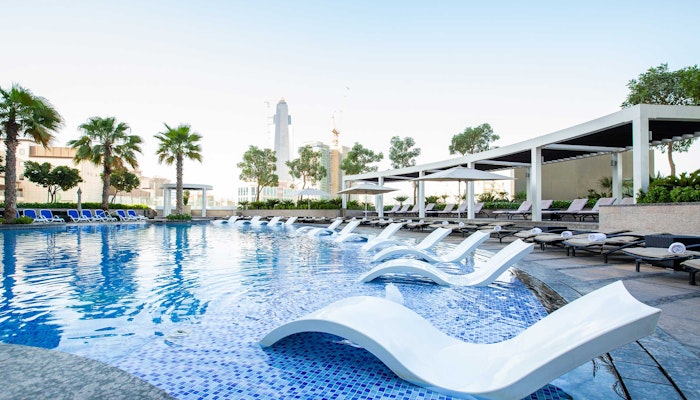 Hyatt Regency Dubai Creek Heights Poolside lounge chairs partially submerged in water