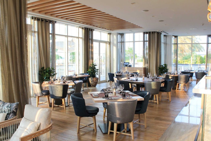 Bright and spacious indoor dining area with large windows, modern decor