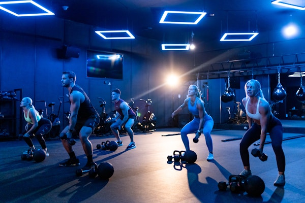 Vital Role of Company Fitness Benefits in Employee Perks, promoting fitness and teamwork. Vital Role of Company Fitness Benefits in Employee Perks: group workout session in a modern gym.