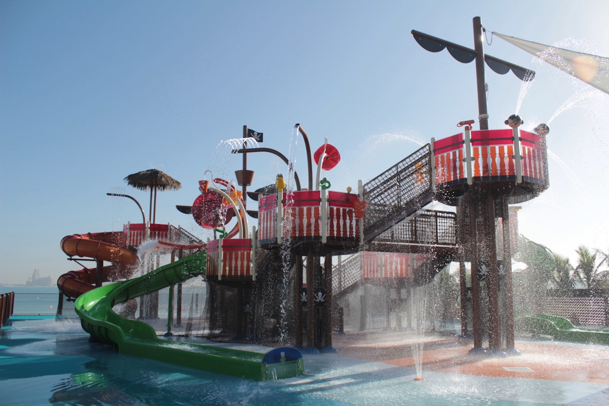 Colorful water playground with slides and water fountains for children.