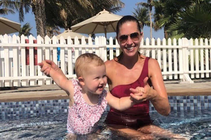 A woman and a baby enjoying a fun moment together in a pool.