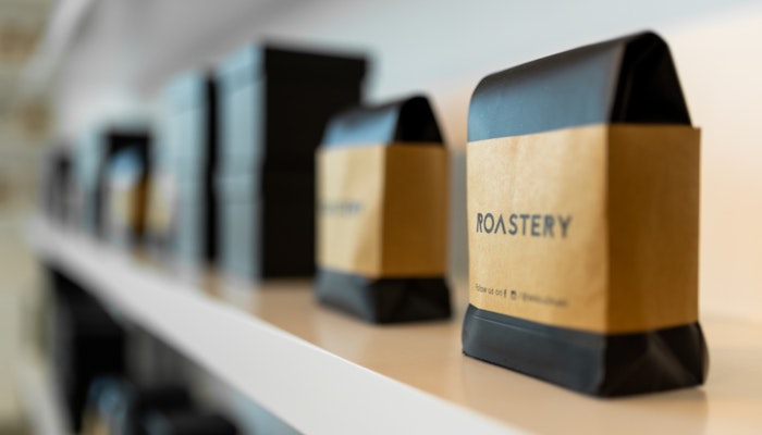 Roastery at W Abu Dhabi - Yas Island Several bags of coffee labeled "ROASTERY" lined up on a shelf.