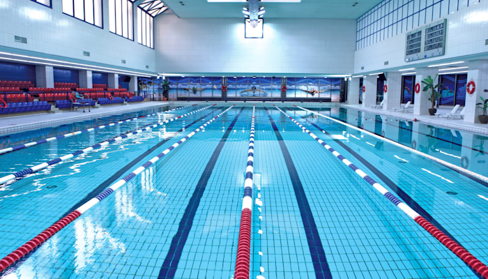 Etizan Fitness (Olympic size indoor lap pool) Indoor swimming pool with lane markers and seating.