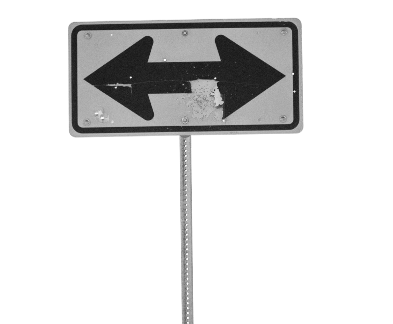 Roadsign with arrows pointing in opposite directions