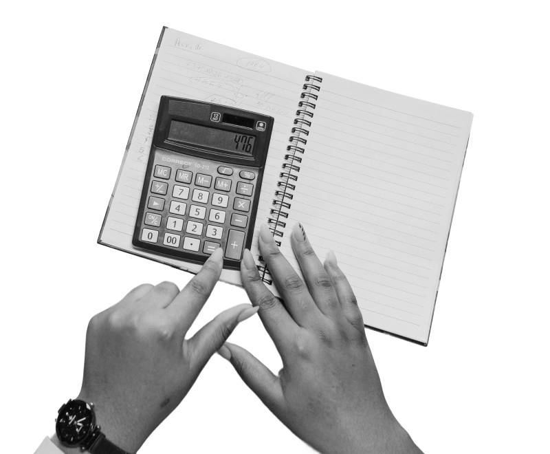 Hands holding a paper note book and typing on a calculator