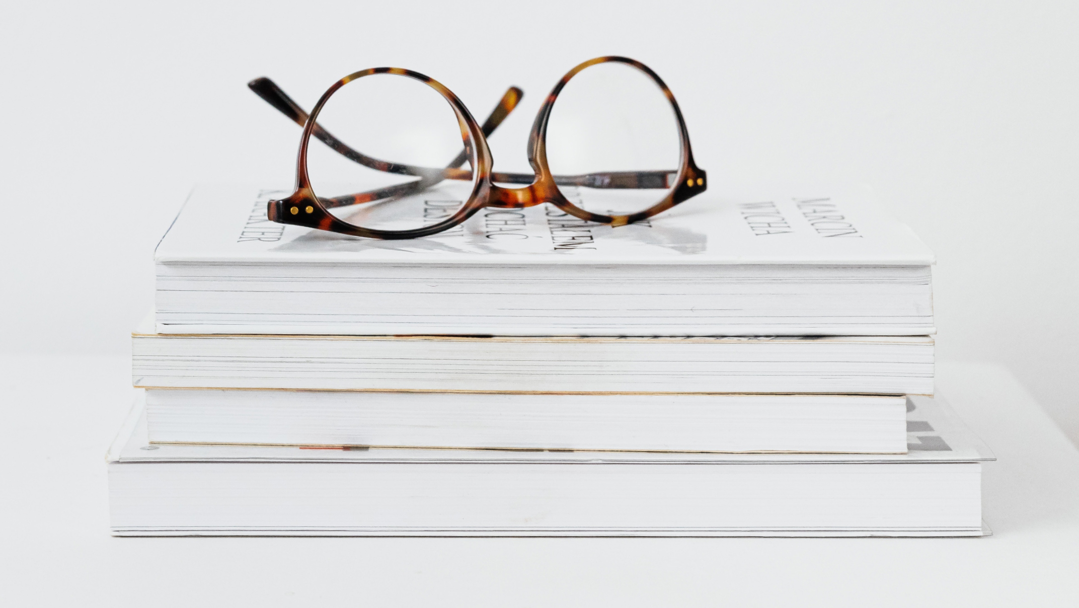 Stack of books with glasses on top