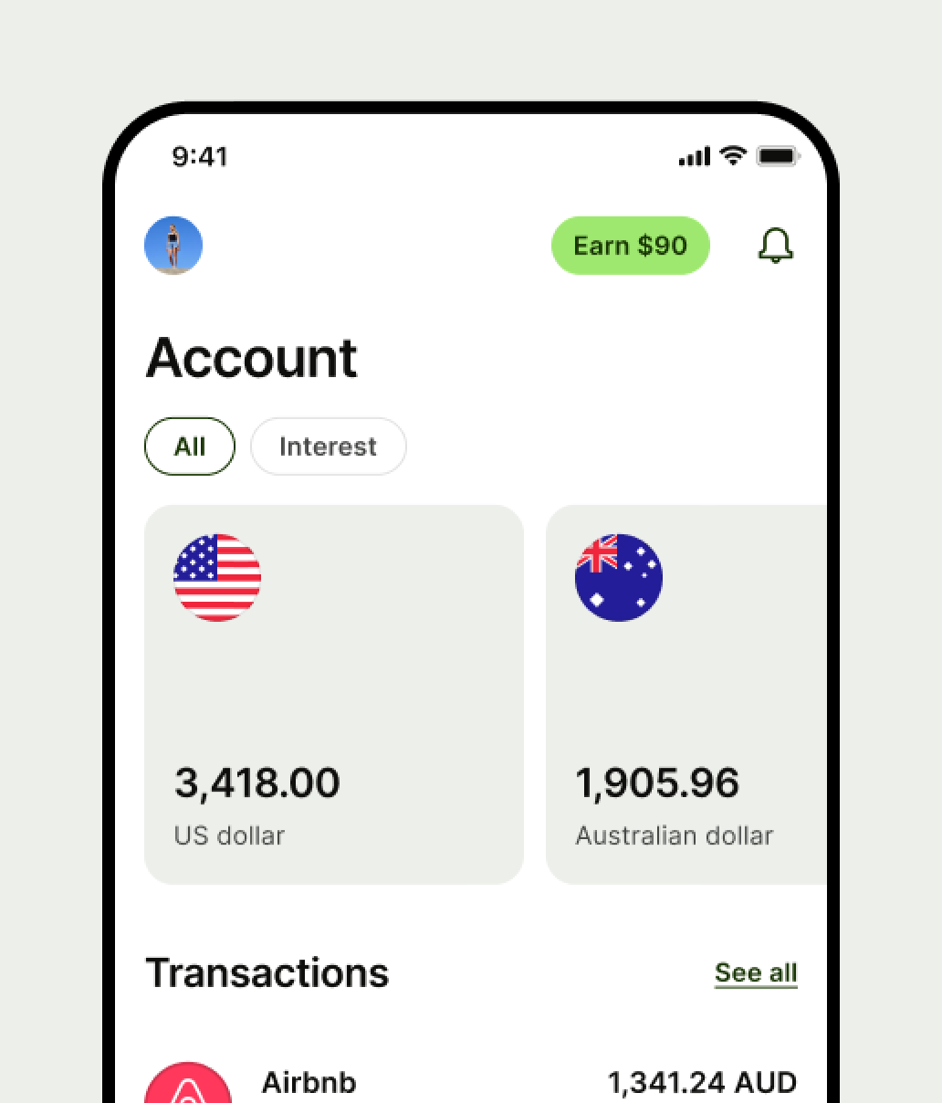 A mobile banking app screen displays account balances: $3,418.00 US dollars with a US flag icon, and $1,905.96 Australian dollars with an Australian flag icon. The "Earn $90" button is shown at the top.