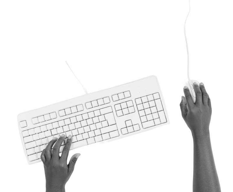 Two hands using a white computer keyboard and mouse on a white background, with one hand on the keyboard and the other on the mouse.