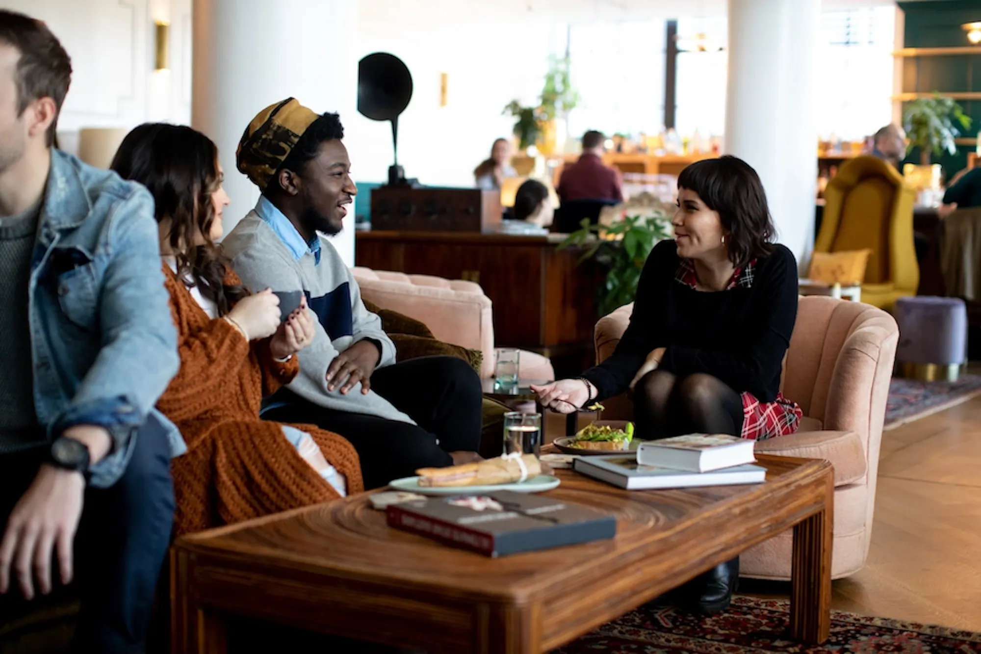 people chatting over food and drink in the lobby