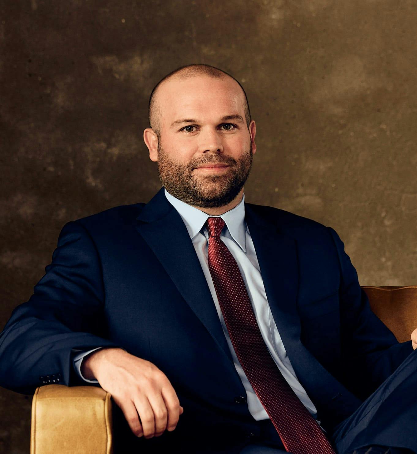 Man in a suit sitting on a chair