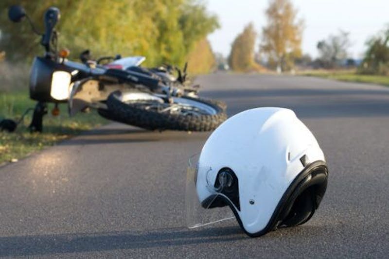 motorcycle and helmet on the ground after an accident