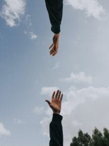 2 people reaching for each other