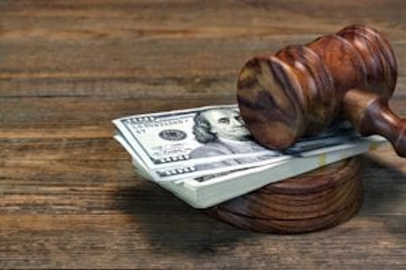 judge gavel and hundred dollar bills
