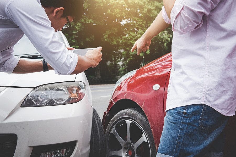 people taking pictures of their cars after being in an accident