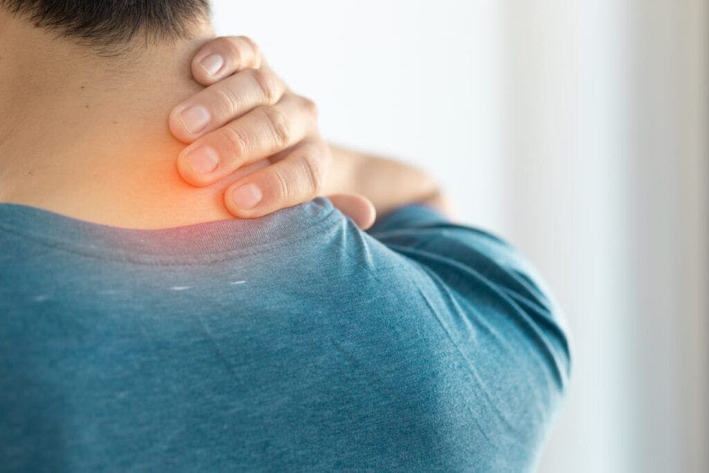 Man holding neck in pain. 