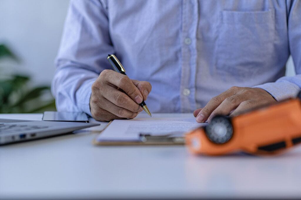 man signing paperwork