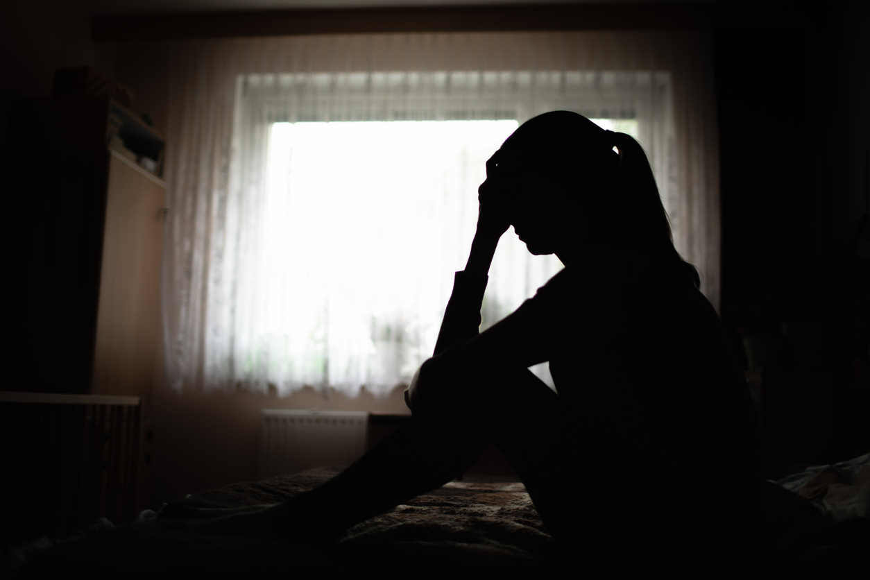 A woman sitting with her head in her hands